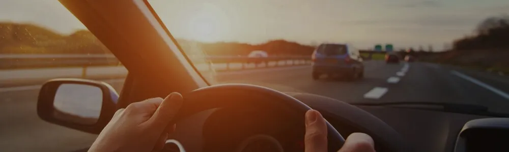 Cars on road with sunny view