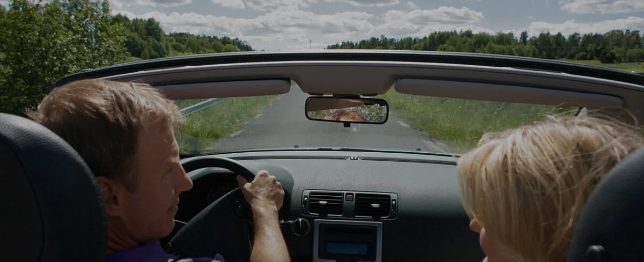 Couple on a convertible on the road