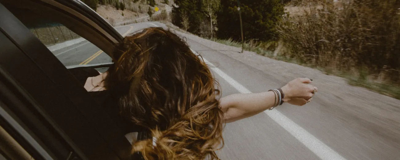 Woman in the car going on road