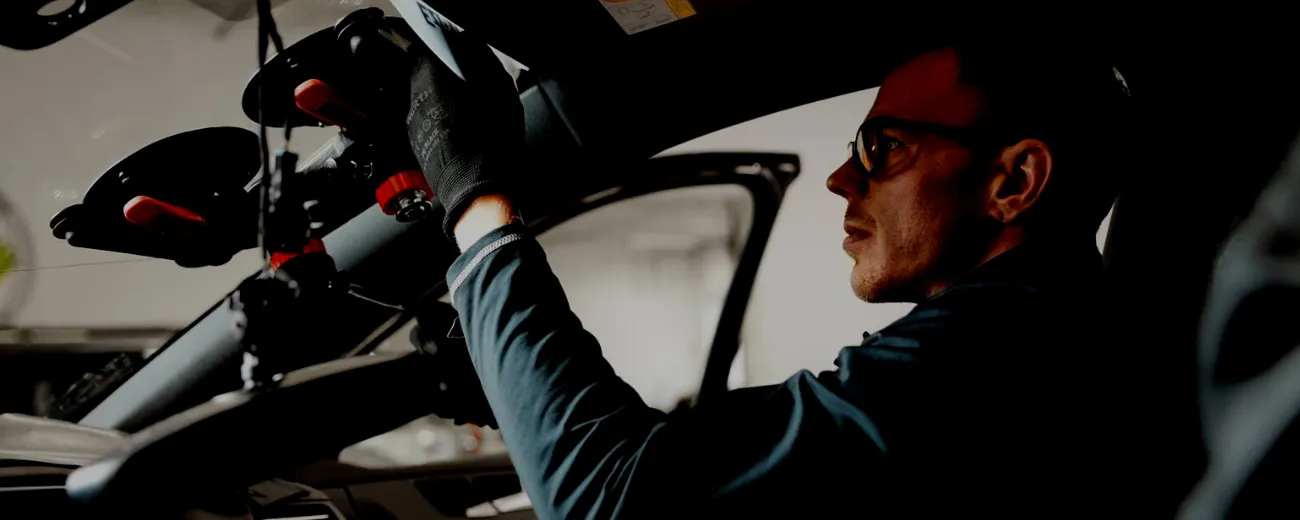 Staff man working on repair inside car