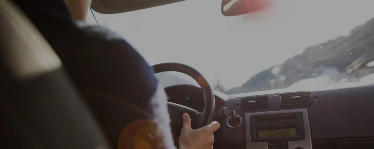 Man driving, view from inside the car