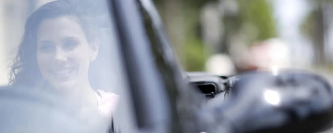 Woman driving and smiliing